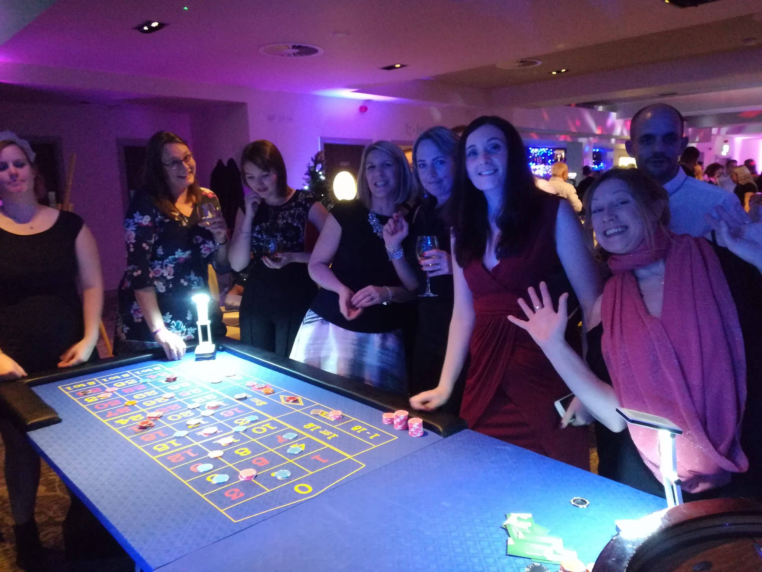 Guests gathered around a roulette table at a Fun Casino Fun night at Bath Racecourse