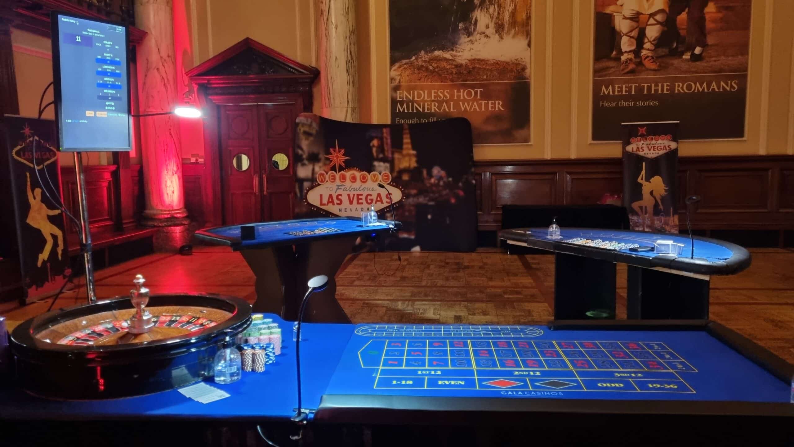 Roulette table, blackjack tables and live roulette display screen set up for a Las Vegas themed event at the Pump Room, Bath