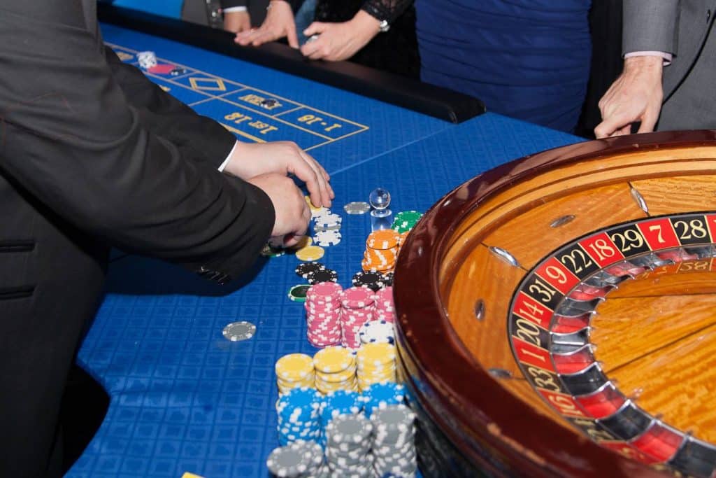 Player stacking chips beside the roulette wheel