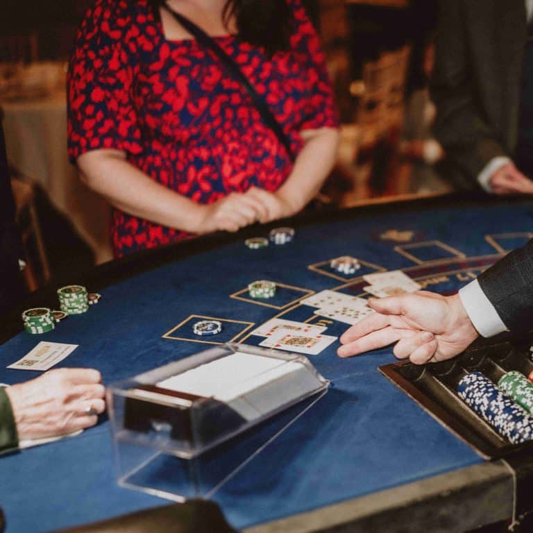 Blackjack dealer pointing to cards