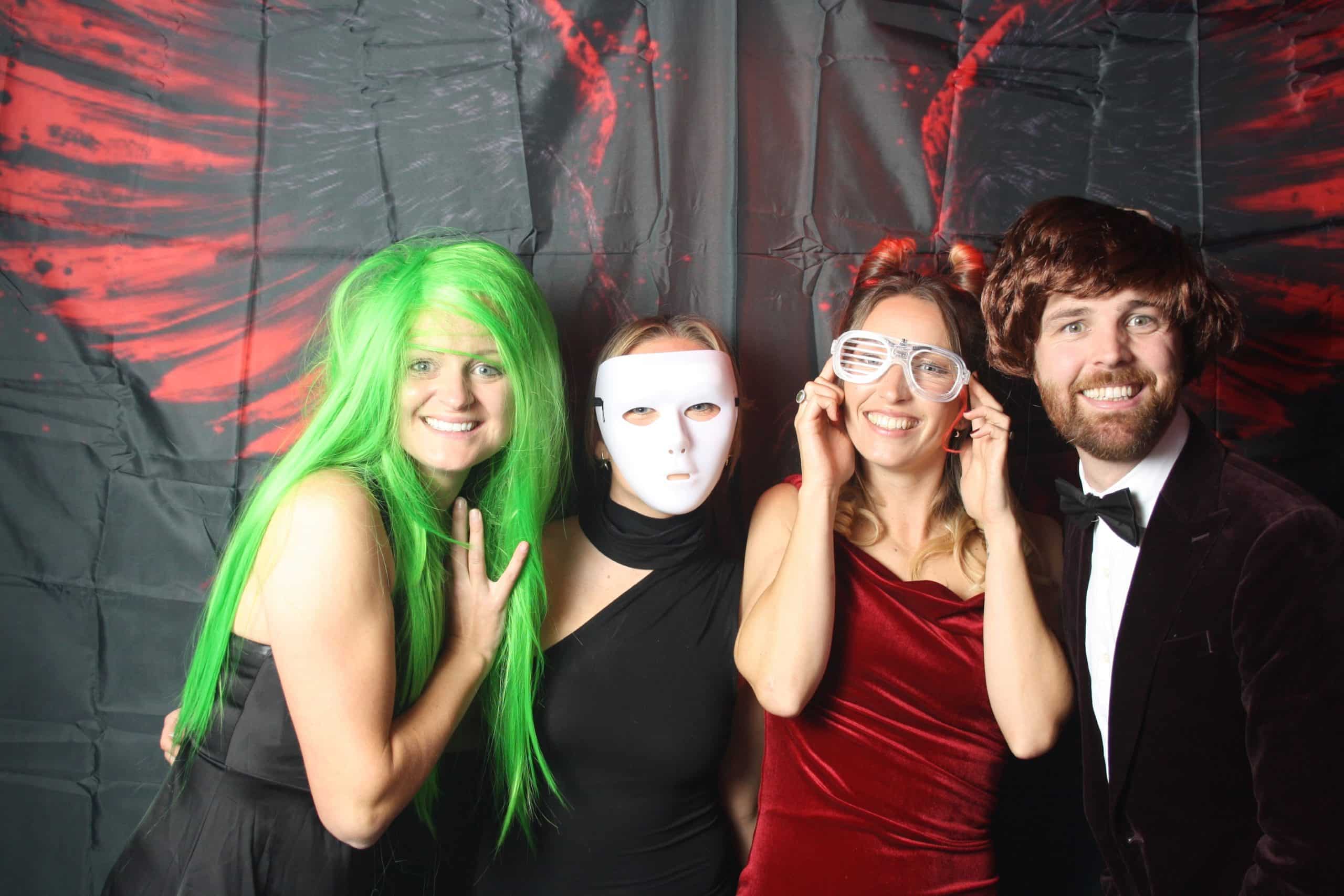 Photobooth 2 Four friends in creative costumes posing for a photo.