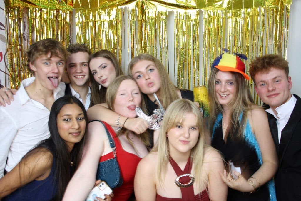 Guests celebrating an 18th birthday party in the open-air photo booth