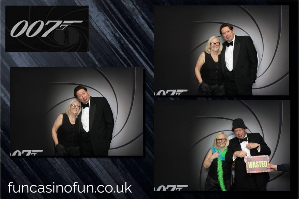 Friends laughing together in the open-air photo booth at an evening celebration